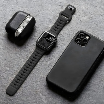 Black Silicone Apple Watch Band With Other Electronics Beside It